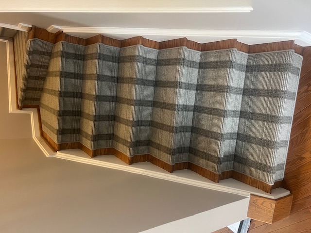 Patterned carpet stair runner on hardwood staircase in Maryland