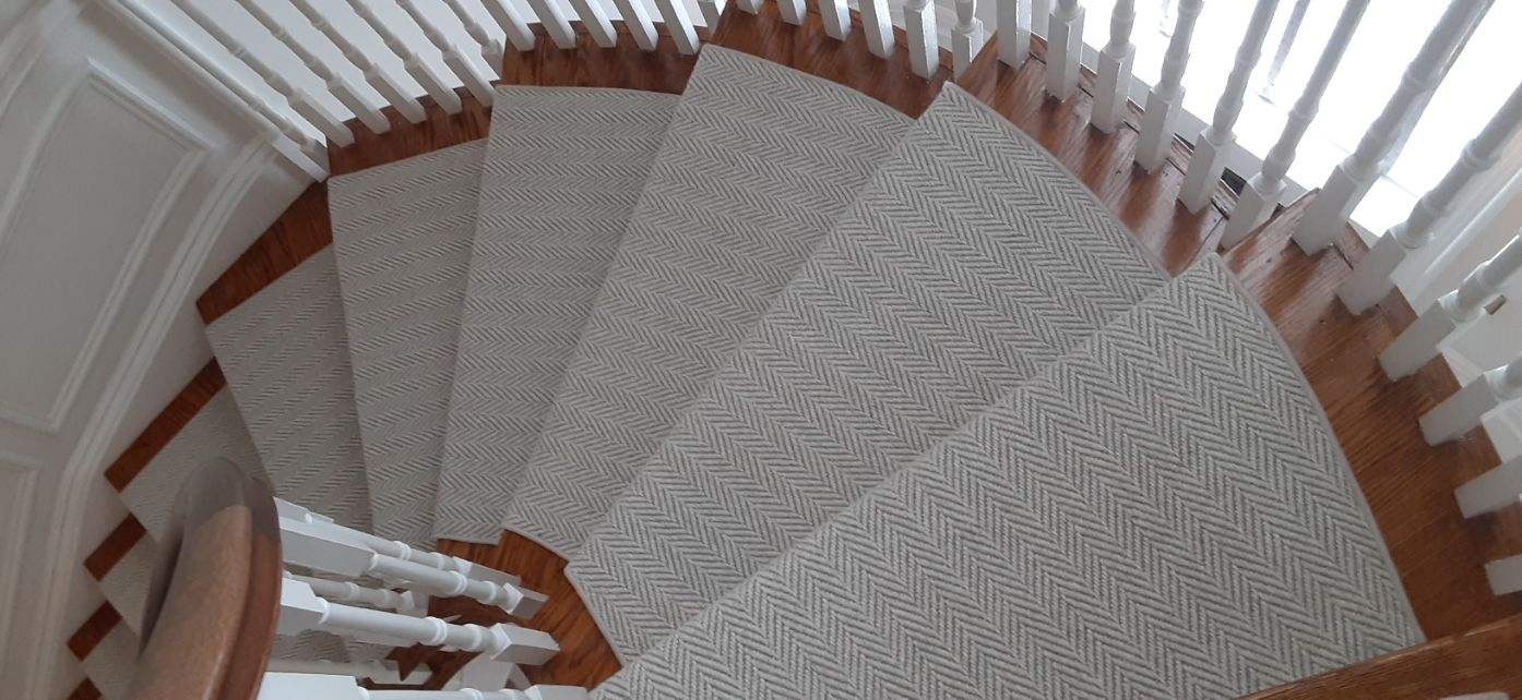 Luxury carpet stair runner with custom binding installed on residential stairs